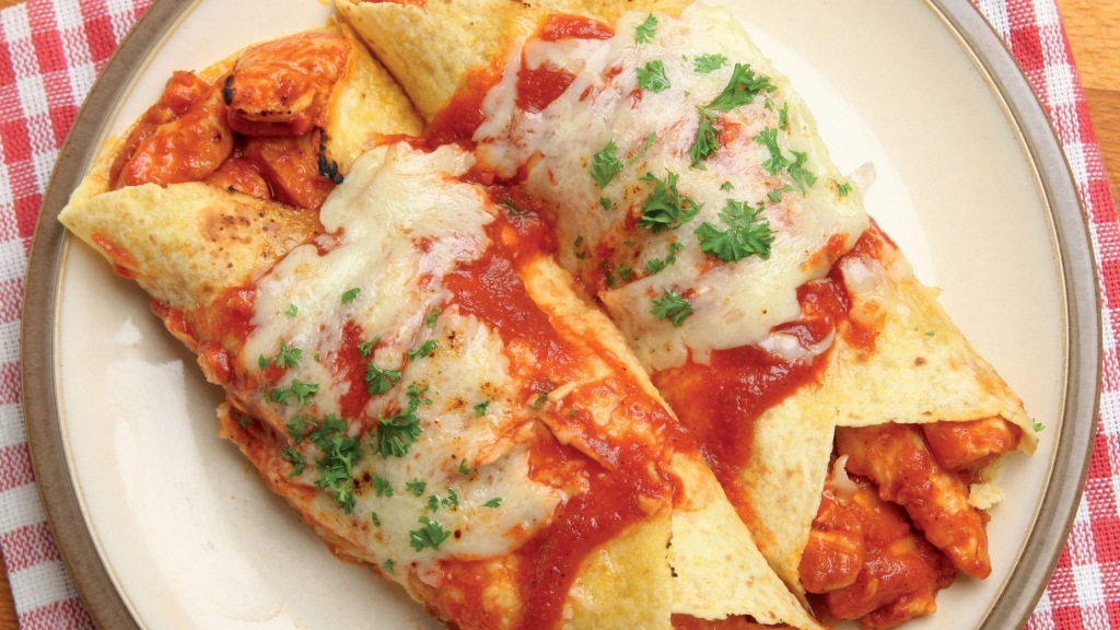 Overhead view of a white plate of Buffalo Chicken Enchiladas