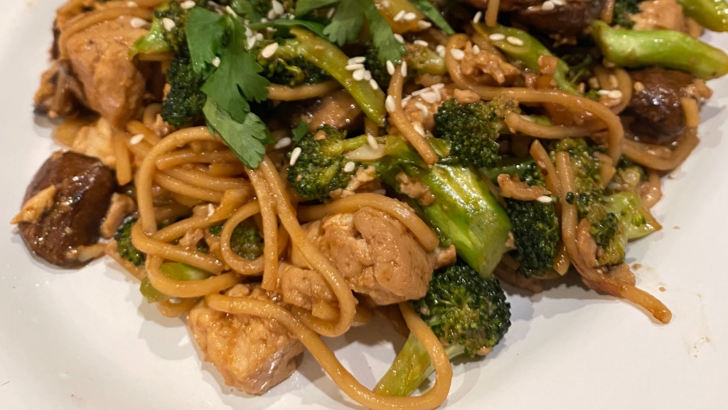 Overhead view of a white plate of Mushroom and Tofu Noodle Stir-Fry