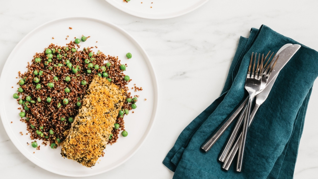 Overhead view of a white plate filled with Herb Crusted Salmon with Quinoa