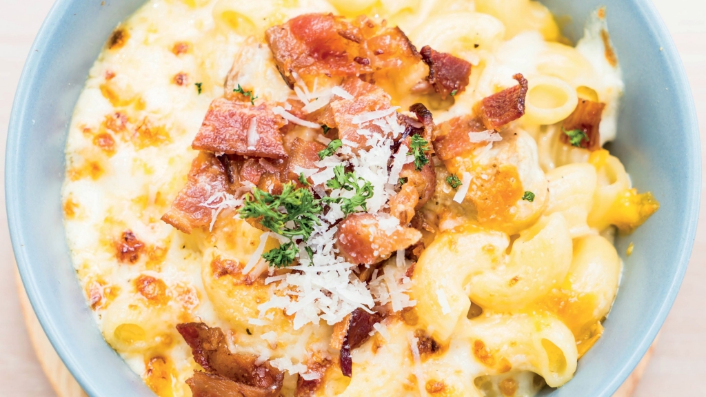 Overhead view of a blue bowl filled with Chicken Bacon Ranch Mac & Cheese